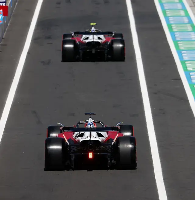 Lewis Hamilton and Charles Leclerc drive out of the pit lane