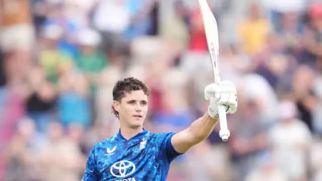 Jacob Bethell lifts his bat to thank the crowd