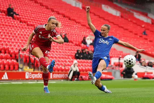 Samantha Kerr of Liverpool shoots whilst under pressure from Rosa van Gool of Everton during the Barclays Women's Super League match between Liverpool and Everton at Anfield on September 07, 2025 in Liverpool, England.