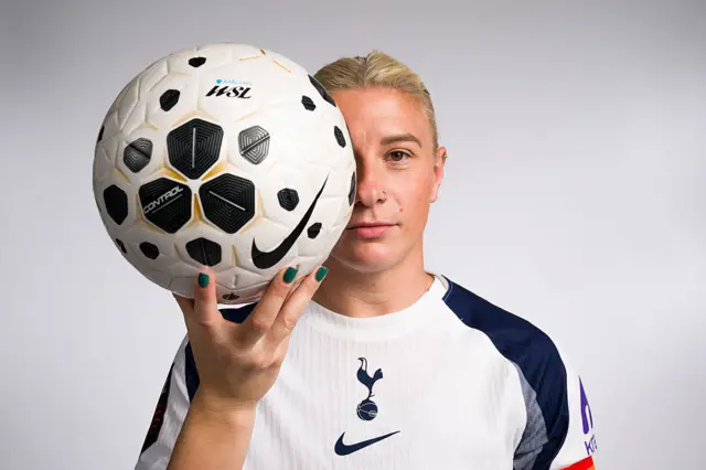 Beth England poses with the new WSL match ball