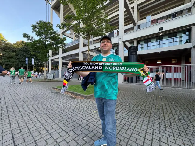 A Germany fan with a half and half scarf
