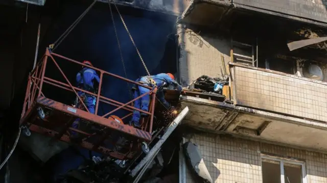 Ukrainian rescuers work at the site of a Russian strike on a nine-story residential building in Kyiv, Ukraine, 07 September 2025, amid the Russian invasion