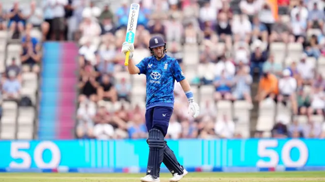 Joe Root lifts his bat in celebration of his half-century vs South Africa.