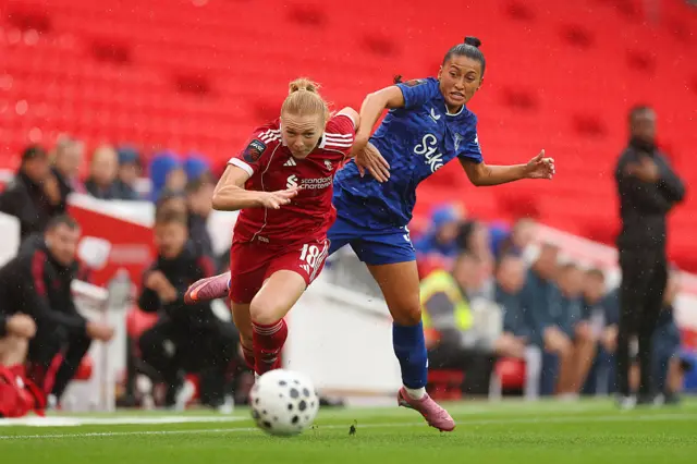 Ceri Holland of Liverpool is challenged by Mayumi Pacheco of Everton during the Barclays Women's Super League match between Liverpool and Everton at Anfield on September 07, 2025 in Liverpool, England.