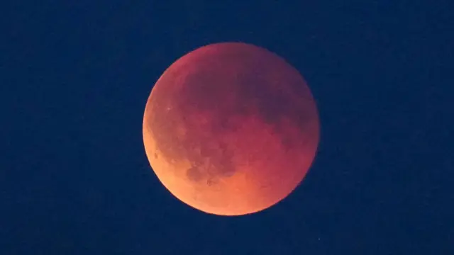 A red-hue moon seen in the sky