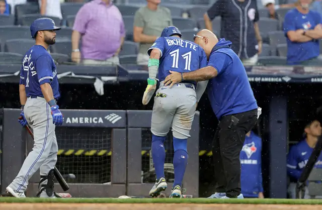 Bo Bichette limps away after clashing with Austin Wells at home plate on Saturday