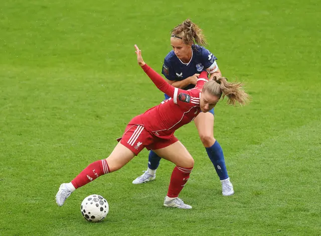 Kirsty MacLean of Liverpool is challenged by Katja Snoeijs of Everton during the Barclays Women's Super League match between Liverpool and Everton at Anfield on September 07, 2025 in Liverpool, England.