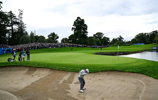Rory McIlroy of Northern Ireland chips out of a bunker