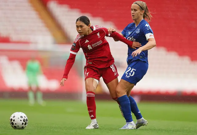 Fuka Nagano of Liverpool is challenged by Katja Snoeijs of Everton during the Barclays Women's Super League match between Liverpool and Everton at Anfield