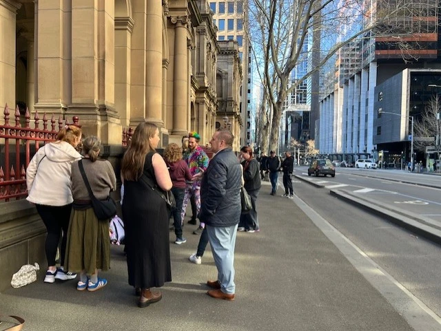 Line of people outside a courthouse