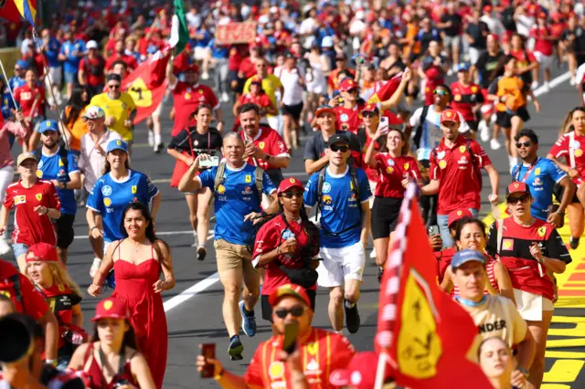 The Tifosi run down the opening straight at Monza