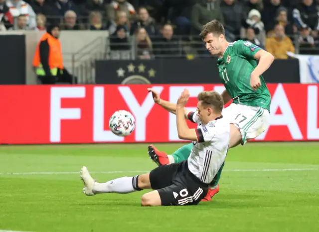 Paddy McNair challenges Joshua Kimmich for the ball
