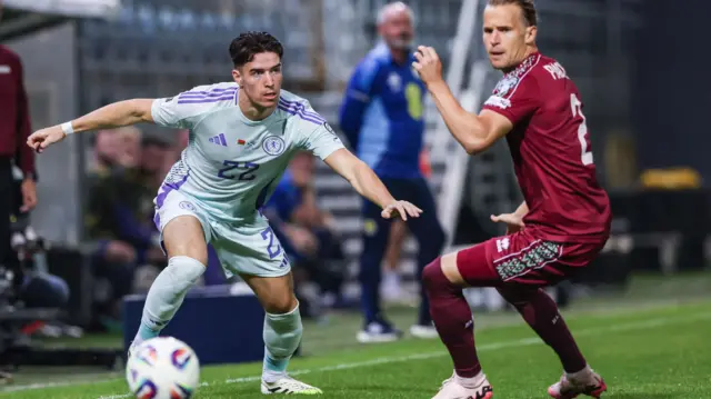 Scotland's Max Johnston (L) and Belarus' Kirill Pechenin in action