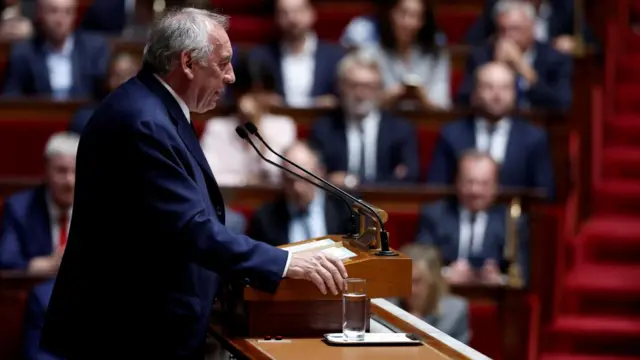 Side view of François Bayrou addressing parliament