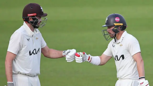 Rory Burns and Dom Sibley touch gloves