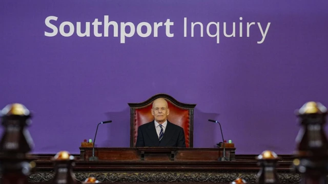 Chair Sir Adrian Fulford sitting inside the hearing room at Liverpool Town Hall, Liverpool, ahead of the start of the inquiry
