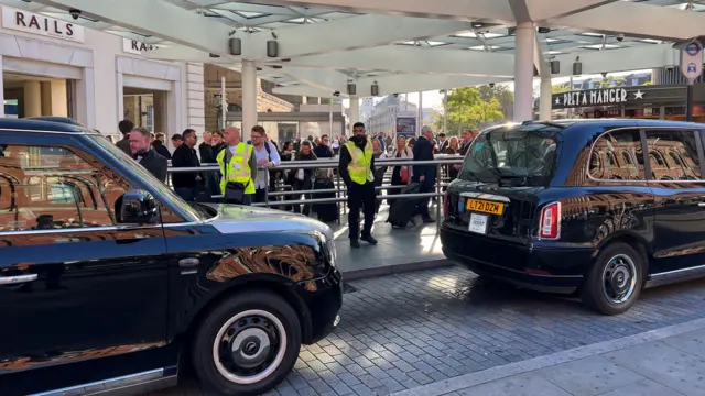 Taxis with queues of people