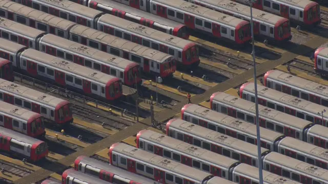 Several underground tube carriages parked at a train depot