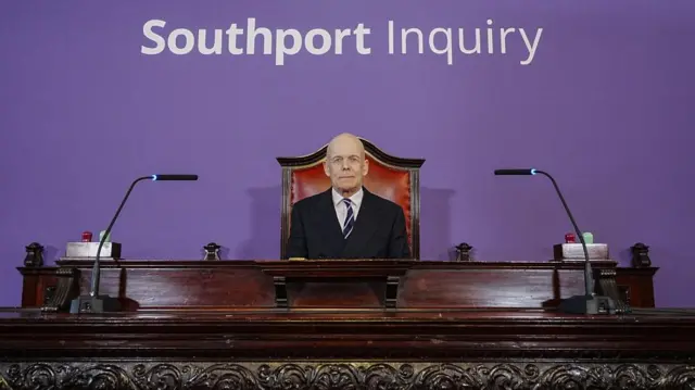Sir Adrian Fulford sitting inside the hearing room at Liverpool Town Hall, Liverpool, ahead of the start of the southport inquiry
