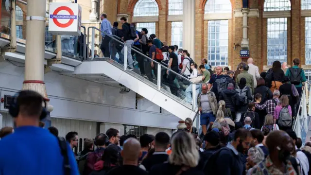 A queue of people trying to leave a station