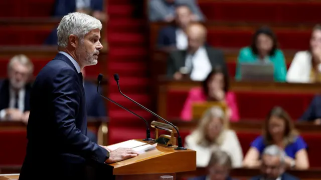 Laurent Wauquiez speaks into a microphone in the National Assembly