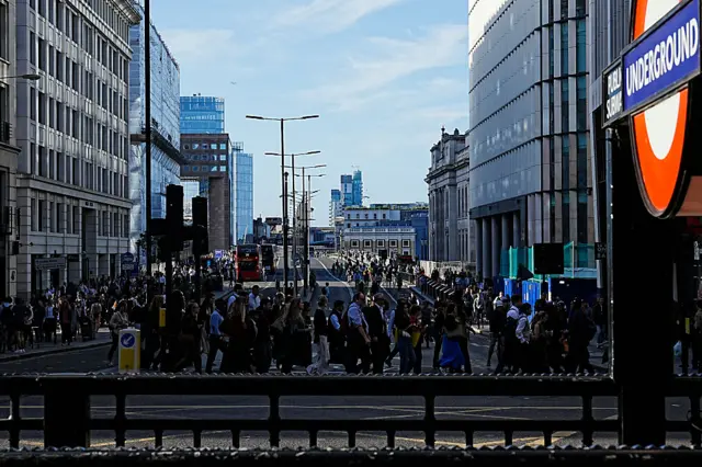Commuters cross London Bridge early in the morning of September 8, 2025, as most of London Underground services are suspended during strike action by members of the Railway workers' union RMT.