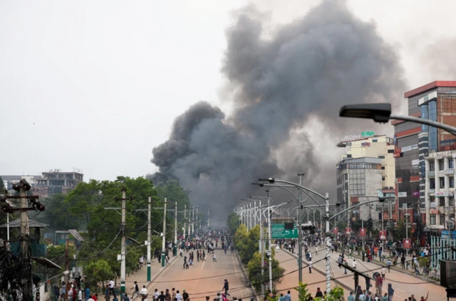 Thick black smoke can be seen rising into the capital's sky after demonstrators set the main gate of the Federal Parliament on fire
