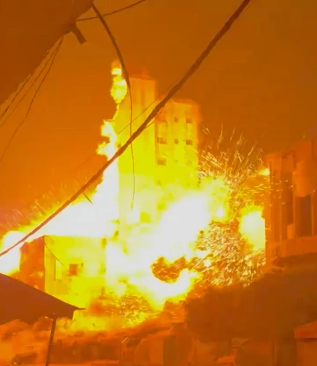 A tower being engulfed by a large fireball