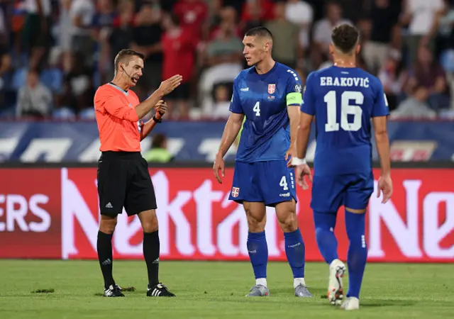 Nikola Milenkovic of Serbia interacts with Referee Clement Turpin after being shown a red card