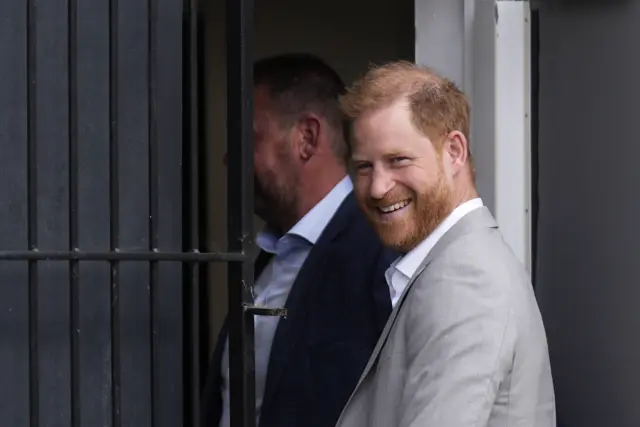 Prince Harry in a grey jacket