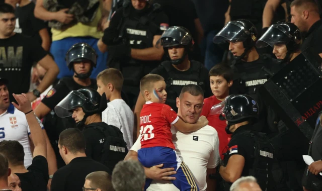 Police officers intervene after Serbia fans clash