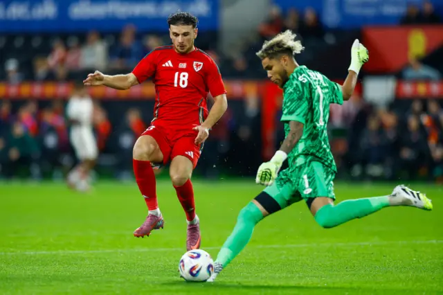 Wales' Mark Harris charges down Canada's Dayne St. Clair