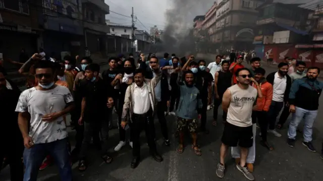 Demonstrators shout slogans and punch their fists into the air as they took to the streets in Kathmandu