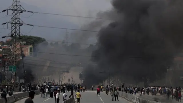 Smoke rises as demonstrators gather again to protest in Kathmandu