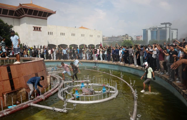 Demonstrators gather after entering the Parliament complex