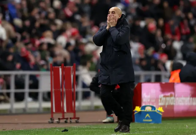 Pep Guardiola, Manager of Manchester City, reacts