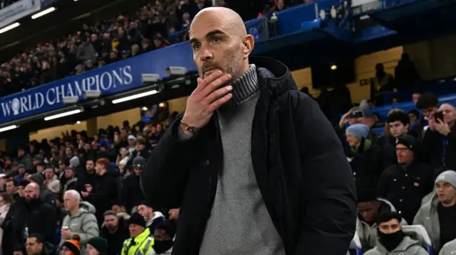 Enzo Maresca rubs his chin on the sideline at Stamford Bridge
