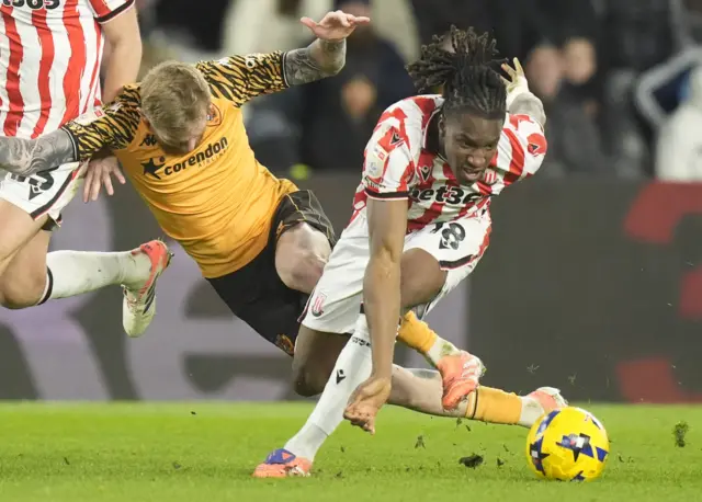 Stoke City's Bosun Lawal and Hull City's Oliver McBurnie battle for the ball