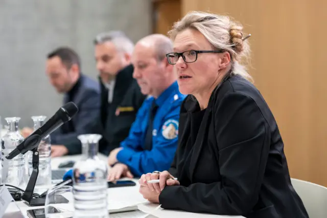 Beatrice Pilloud speaks alongside other officials