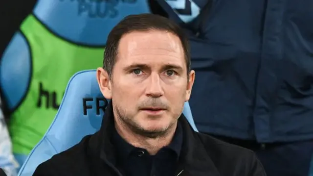 Coventry boss Frank Lampard sat down looking out to the pitch from the touchline.
