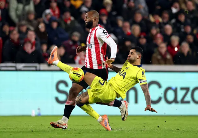 Igor Thiago of Brentford is challenged by Cristian Romero