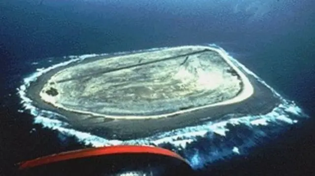 A view of the small and flat island as seen from a plane - there are no structures visible