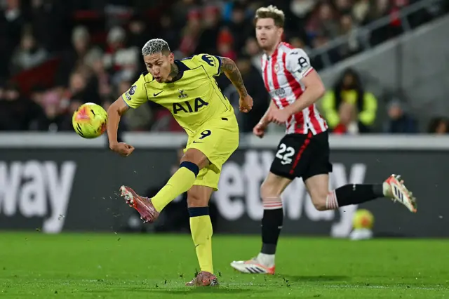 Tottenham Hotspur's Brazilian striker #09 Richarlison (L) passes the ball near Brentford's Irish defender #22 Nathan Collins
