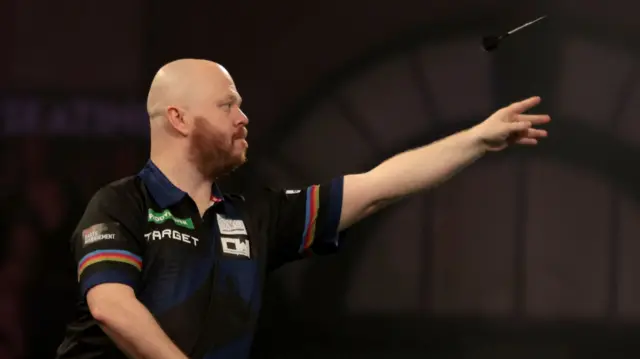 Justin Hood throws a dart