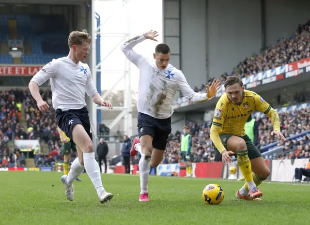 Blackburn Rovers' Lewis Miller and Wrexham's Callum Doyle battle for the ball