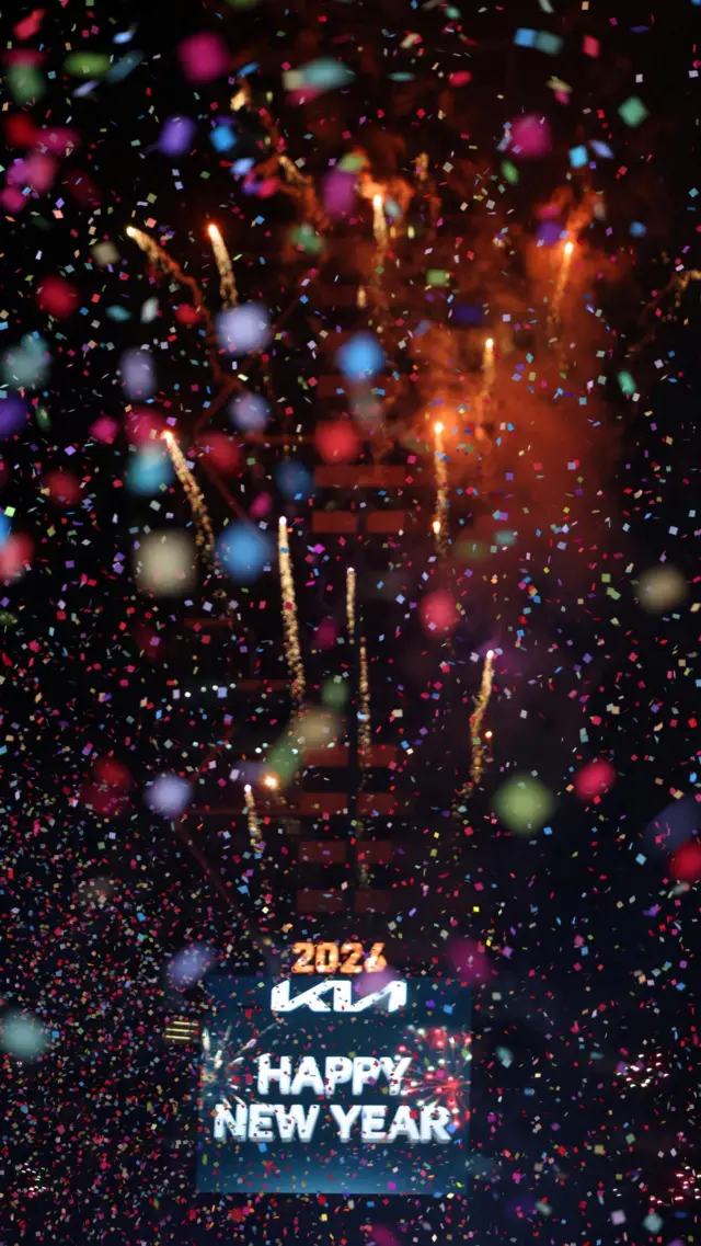 A screen that reads Happy New Year is visible behind colourful confetti