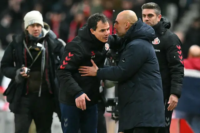 Manchester City's Spanish manager Pep Guardiola (R) shakes hands with Sunderland's French head coach Regis Le Bris