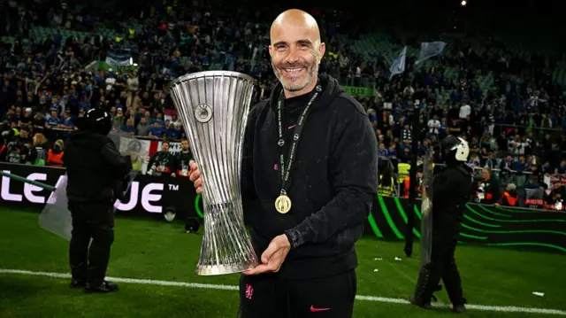 Enzo Maresca poses with the Conference League trophy