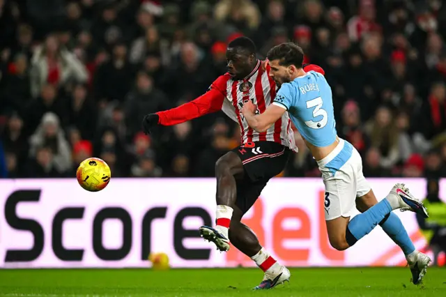Sunderland's Dutch striker #09 Brian Brobbey (L) beats Manchester City's Portuguese defender #03 Ruben Dias