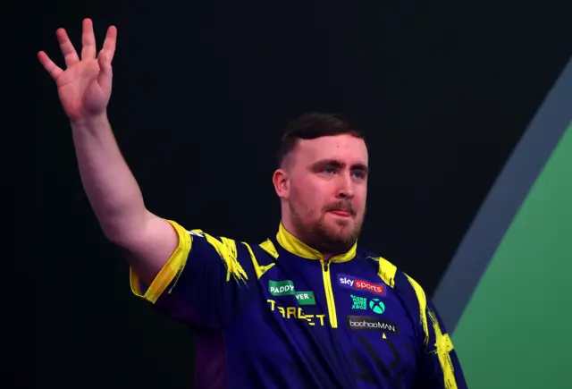 Luke Littler waves to the crowd